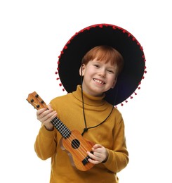 Cute boy in Mexican sombrero hat playing ukulele on white background
