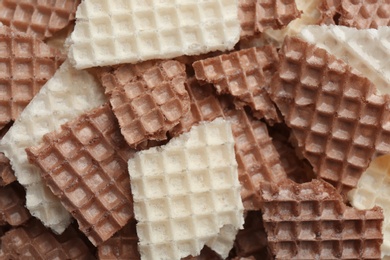 Tasty crumbled wafers as background, top view. Crispy food