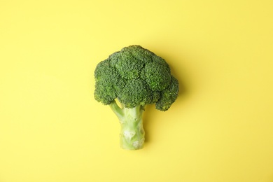 Photo of Fresh green broccoli on color background, top view. Organic food