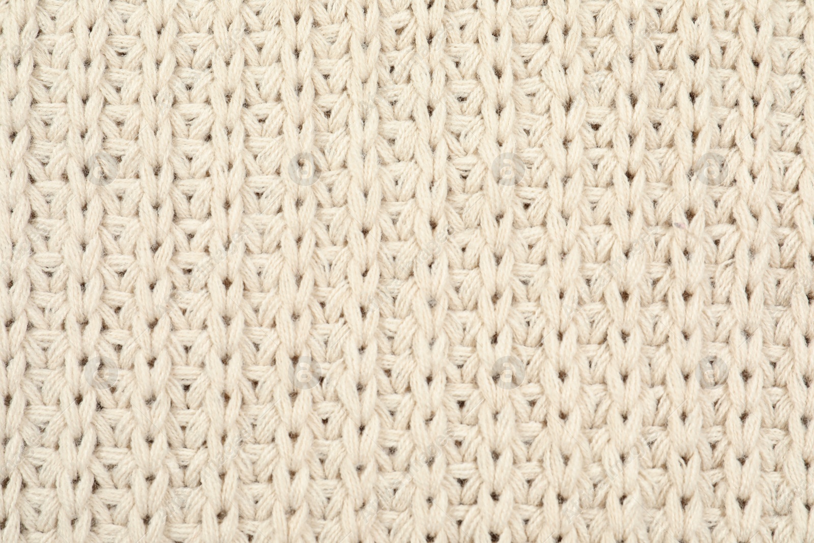 Photo of Texture of cozy warm sweater as background, closeup