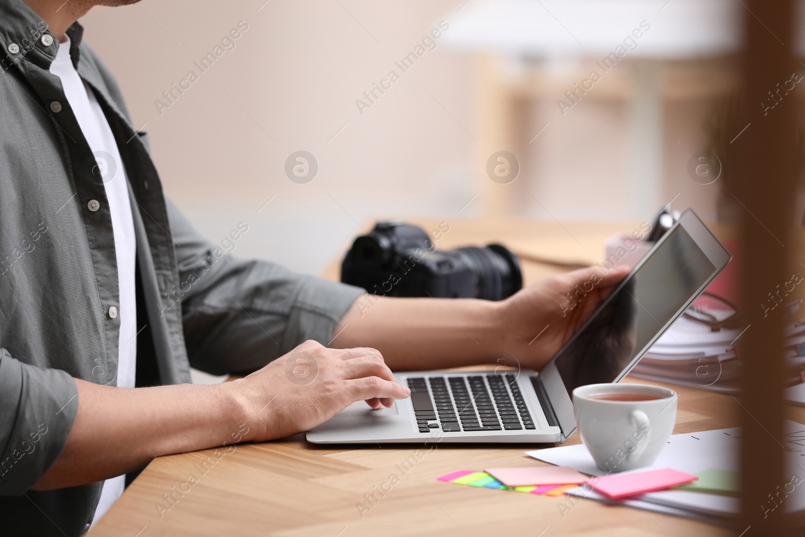 Photo of Professional journalist working with laptop in office, closeup