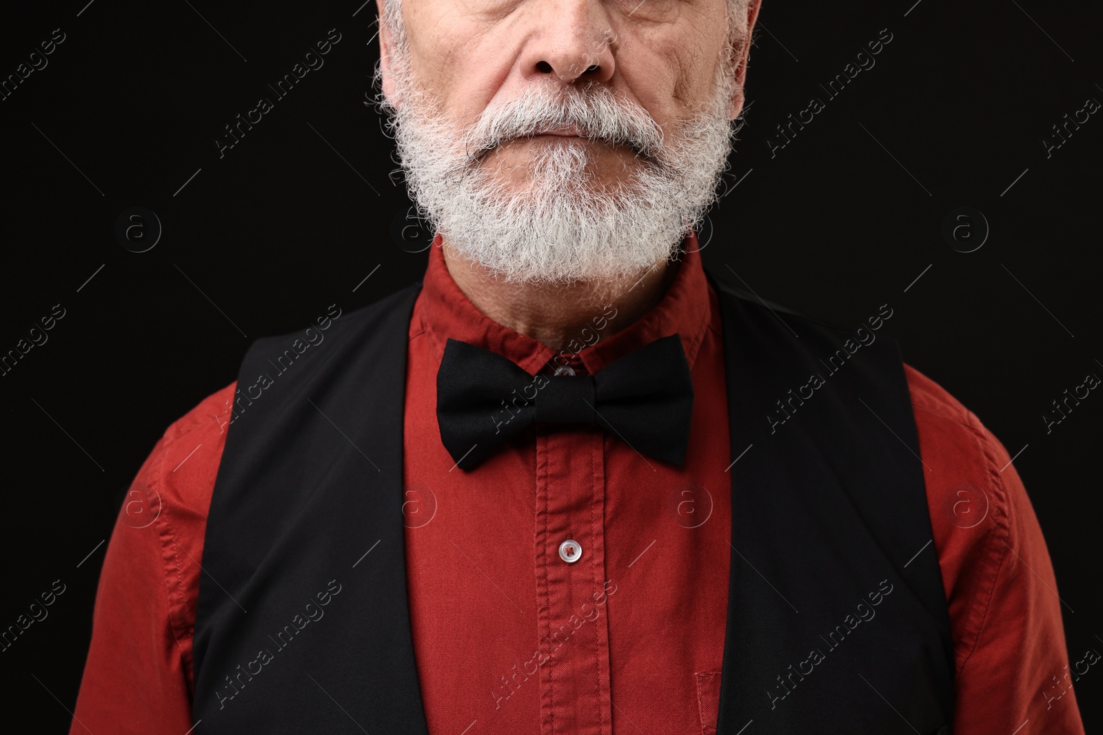 Photo of Man with mustache on black background, closeup