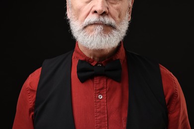 Photo of Man with mustache on black background, closeup