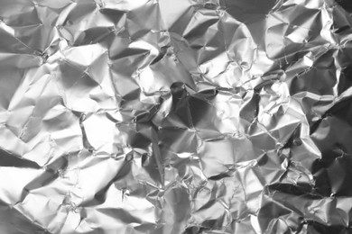 Photo of Crumpled silver foil as background, closeup view