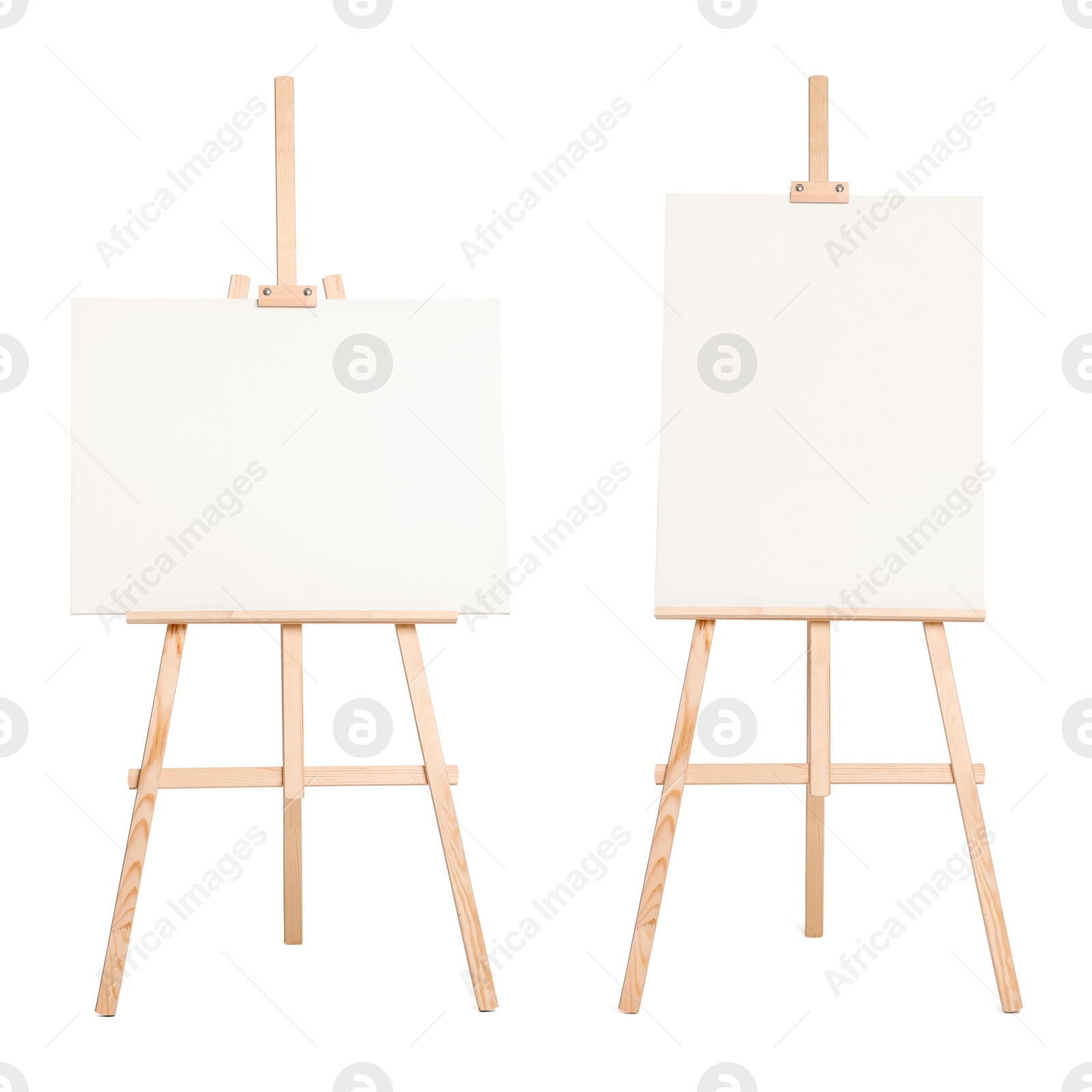 Image of Wooden easel with different canvases isolated on white