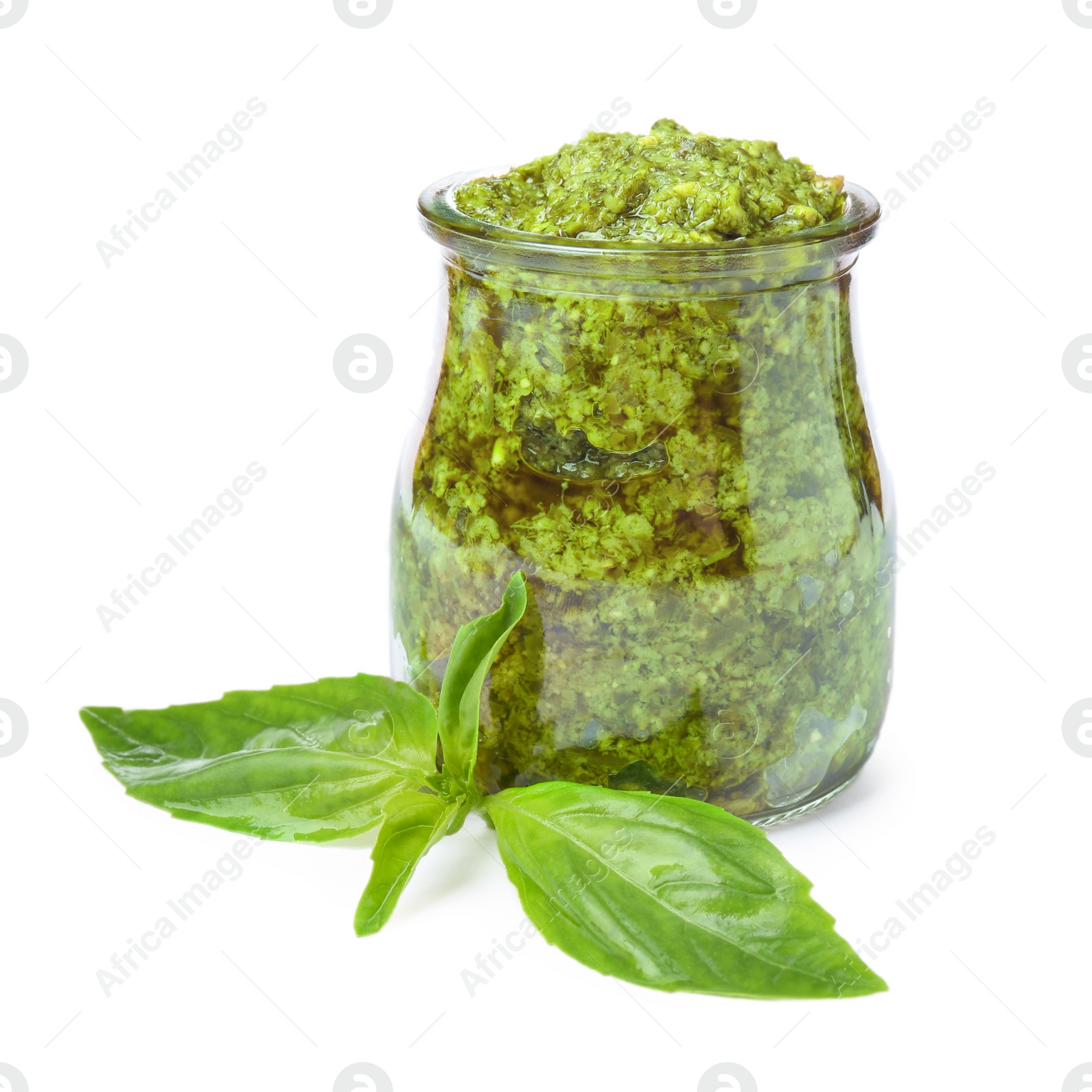 Photo of Jar of tasty pesto sauce and basil leaves isolated on white