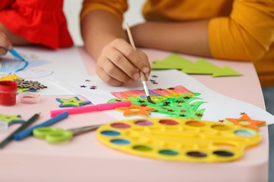 Little children drawing at table indoors, closeup. Christmas season