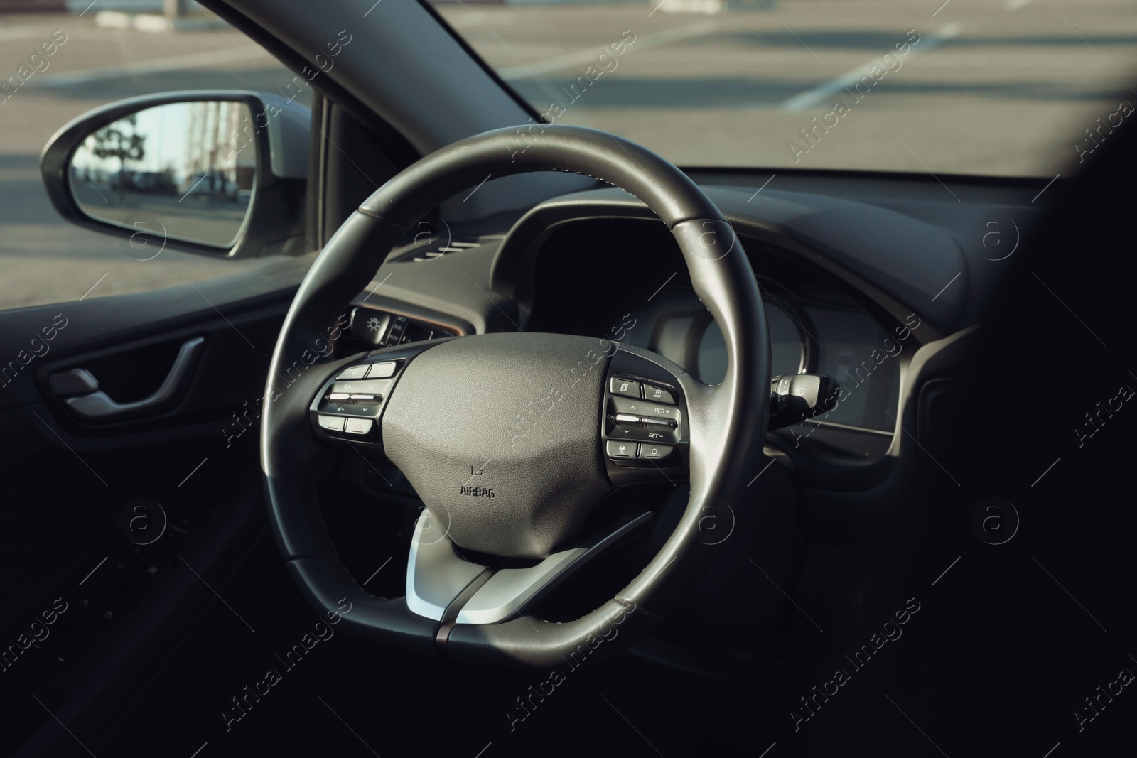 Photo of Black steering wheel inside of modern car
