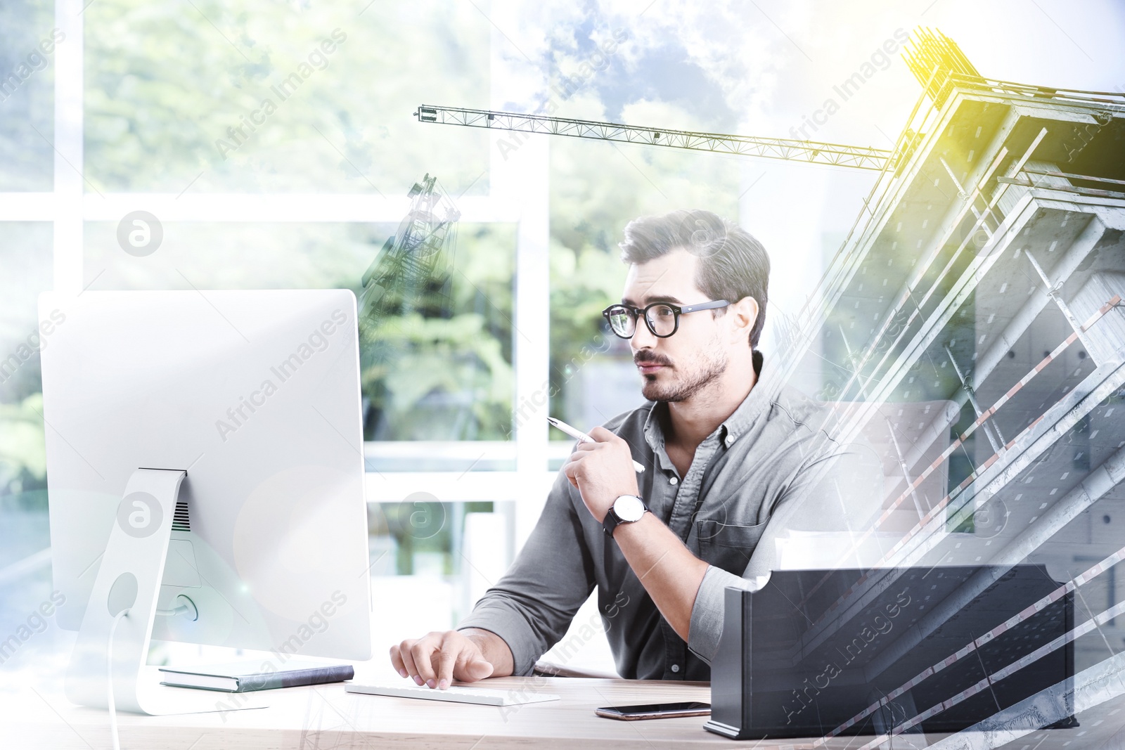 Image of Double exposure of architect working with computer at table and construction site