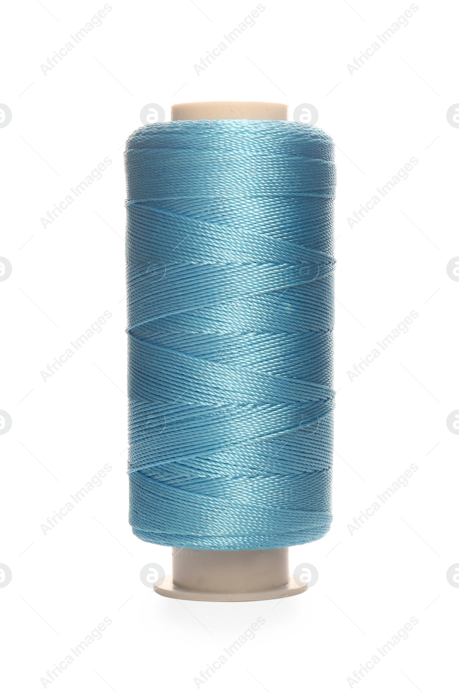 Photo of Spool of light blue sewing thread isolated on white