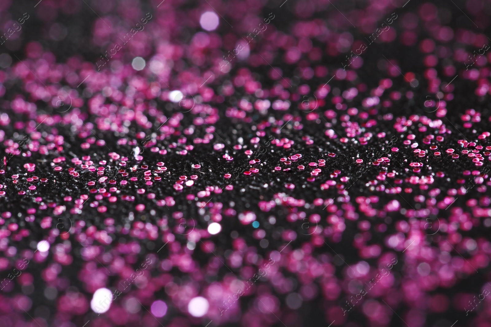 Photo of Pink glitter with bokeh effect on dark background