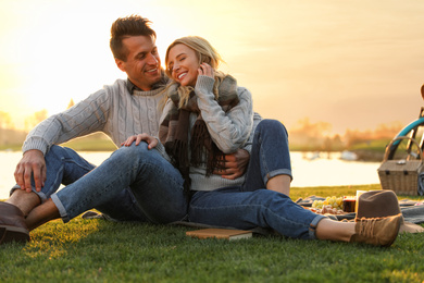 Happy young couple spending time together on picnic outdoors