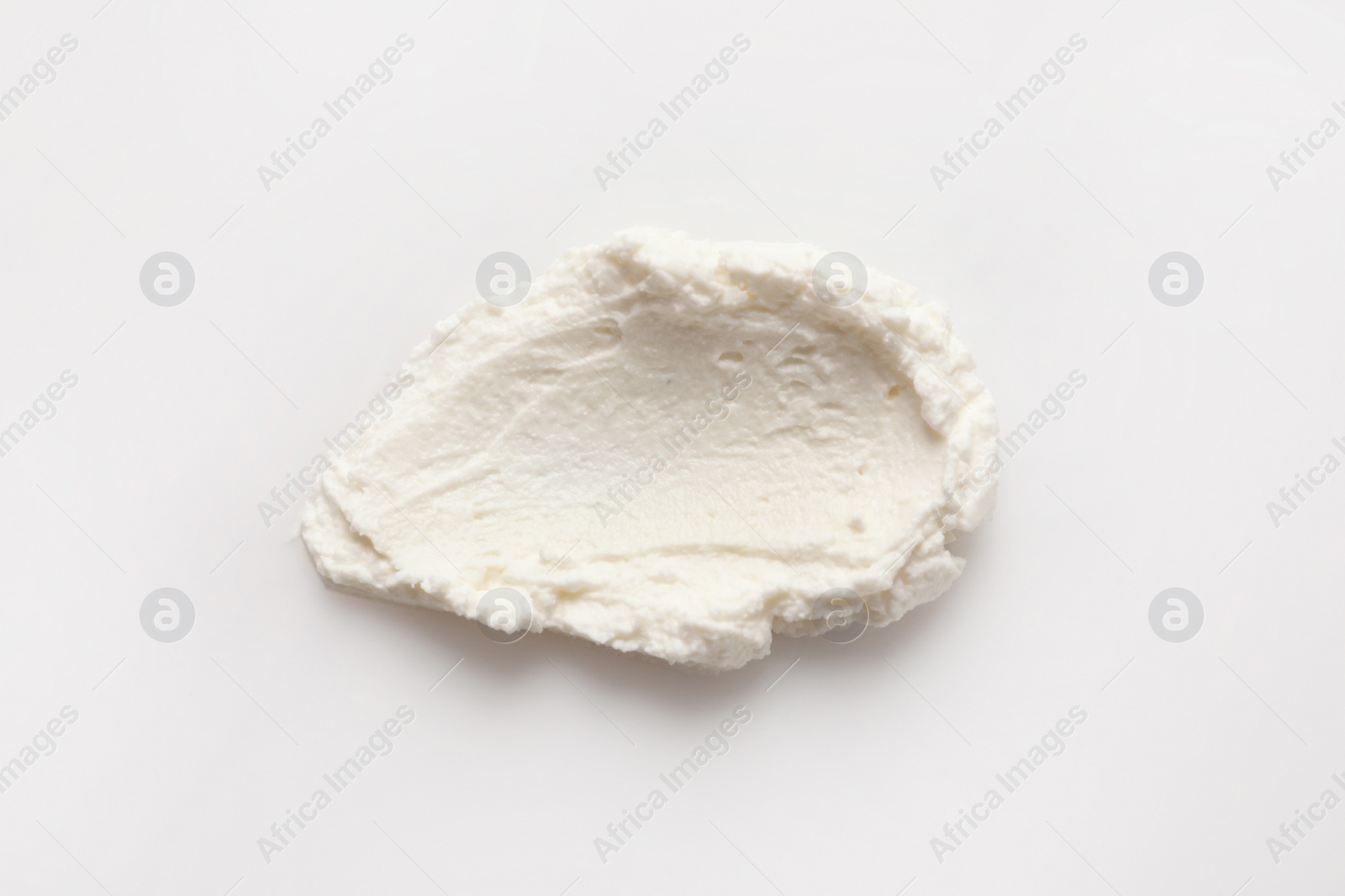 Photo of Smear of tasty cream cheese on white background, top view