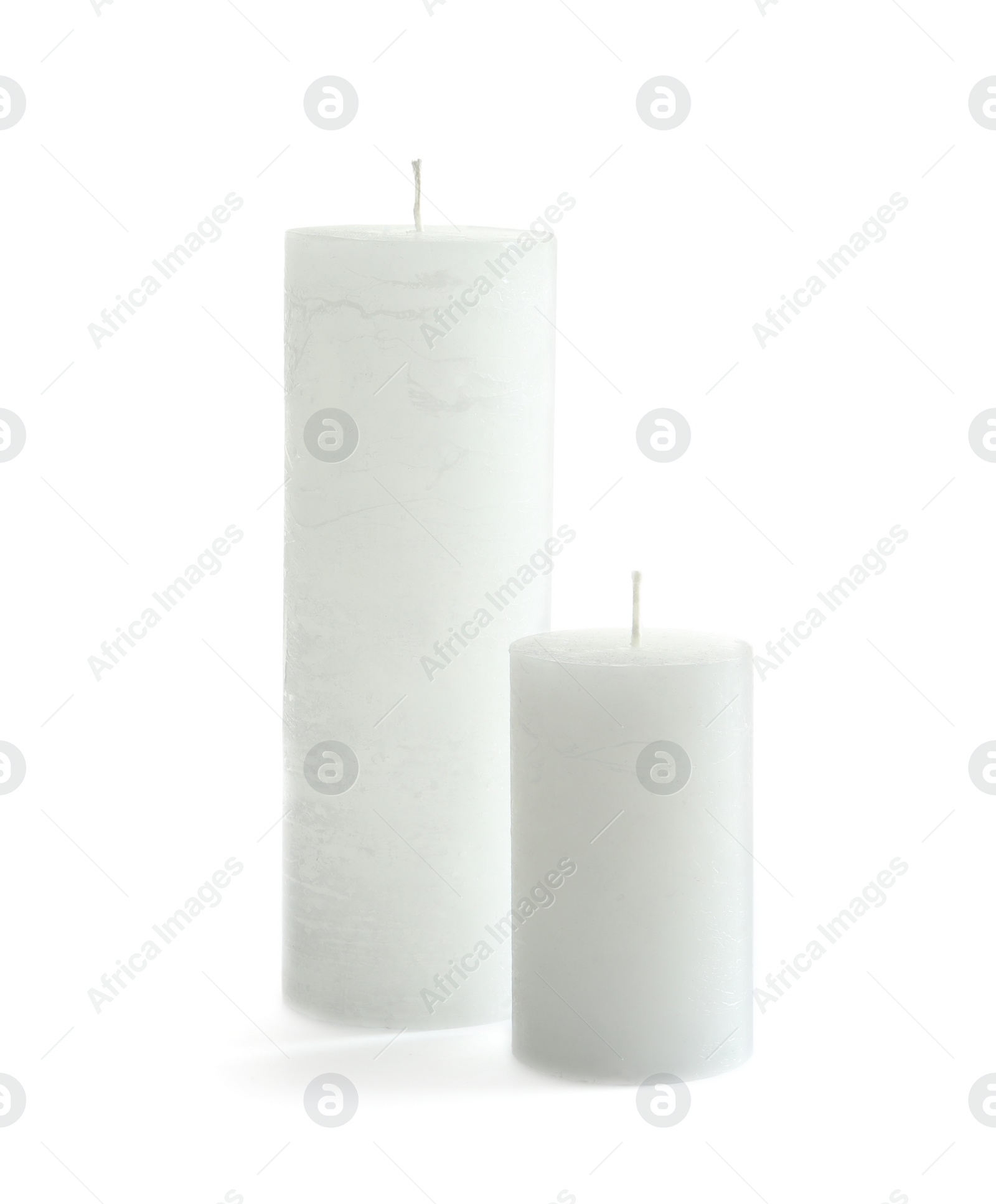 Photo of Different pillar wax candles on white background