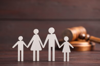 Photo of Family law. Figure of parents with children and gavel on wooden table