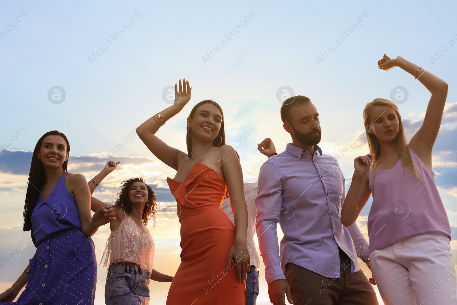 Photo of Group of friends having fun at summer party, low angle view