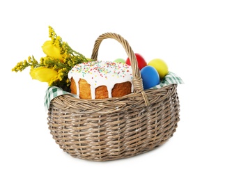 Photo of Traditional Easter cake, eggs and flowers in basket isolated on white