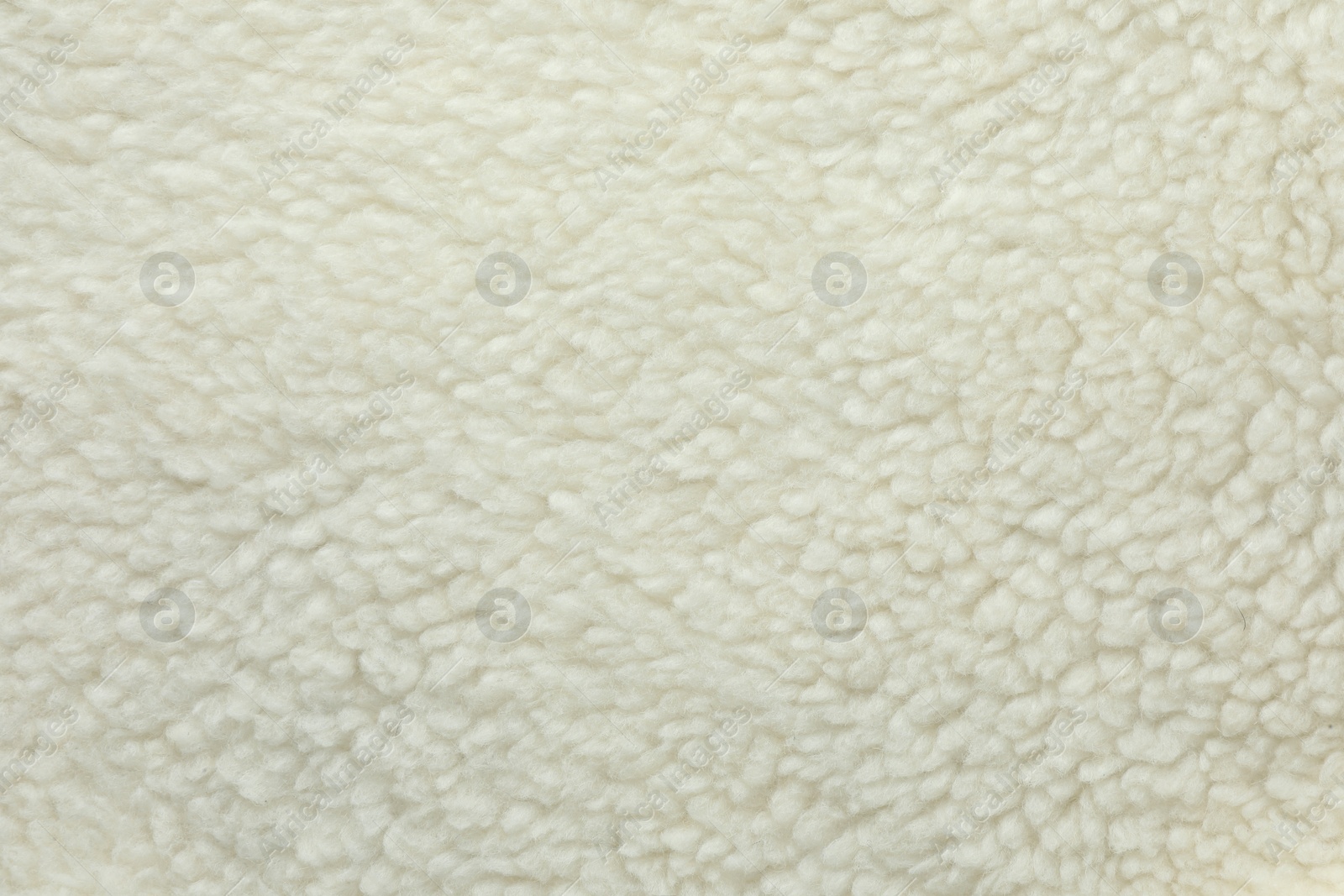 Photo of Texture of white fleece fabric as background, top view