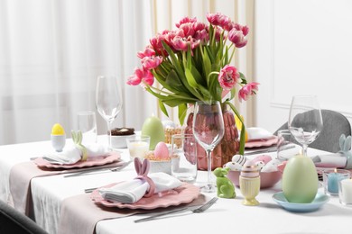 Photo of Festive table setting with beautiful flowers. Easter celebration