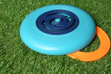 Photo of Plastic frisbee disk and ring on green grass, closeup