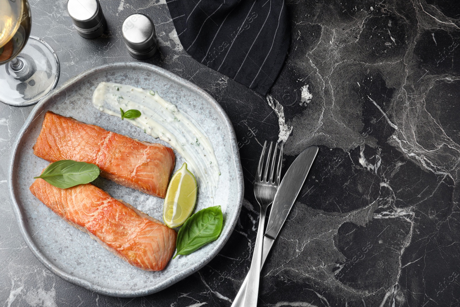 Photo of Tasty cooked red fish on dark marble table, flat lay. Space for text