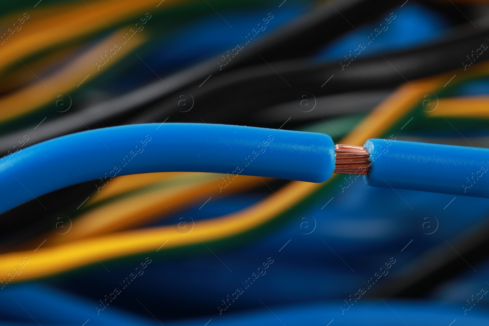 Photo of New light blue electrical wire on blurred background, closeup view