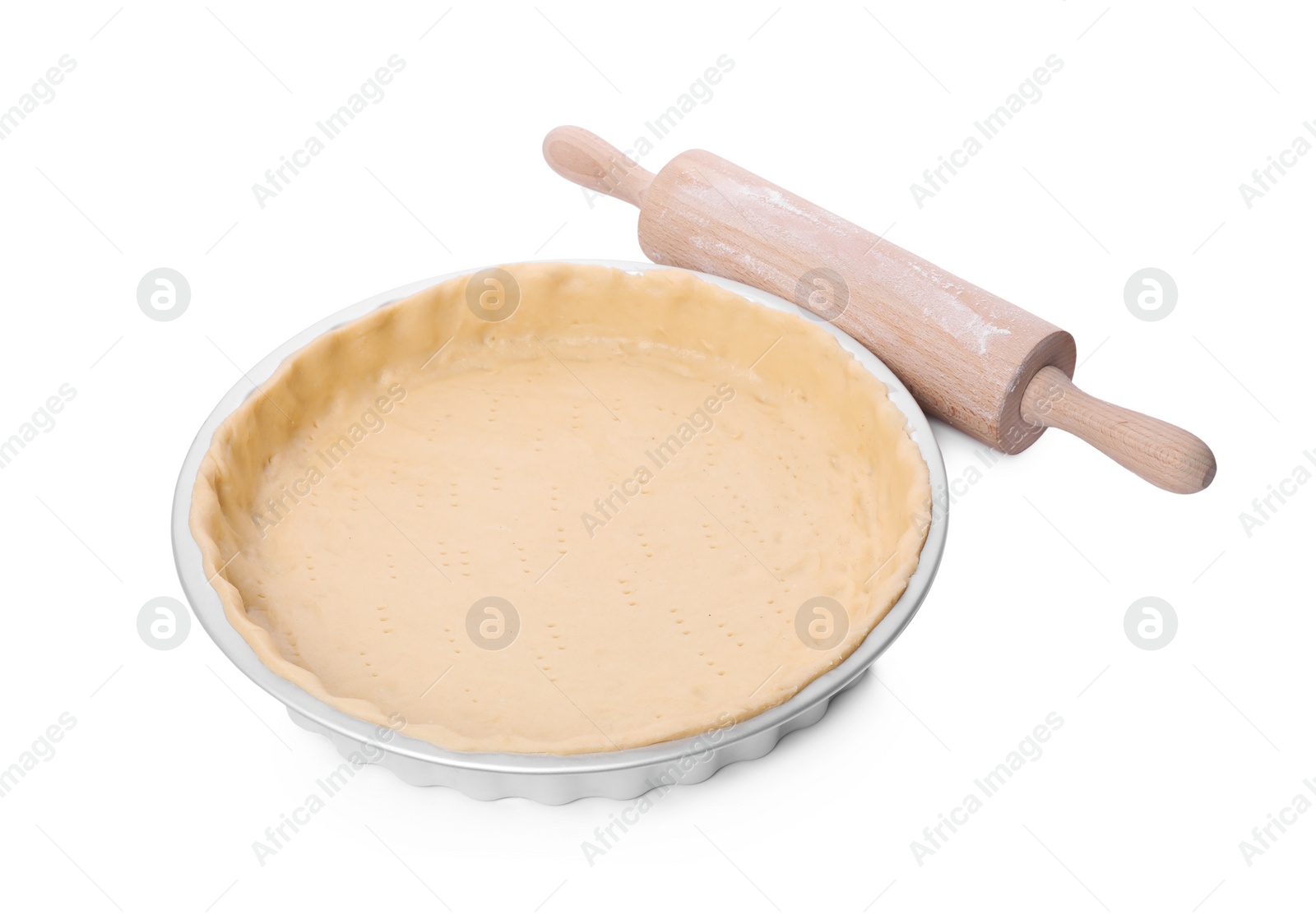 Photo of Quiche pan with fresh dough and rolling pin isolated on white