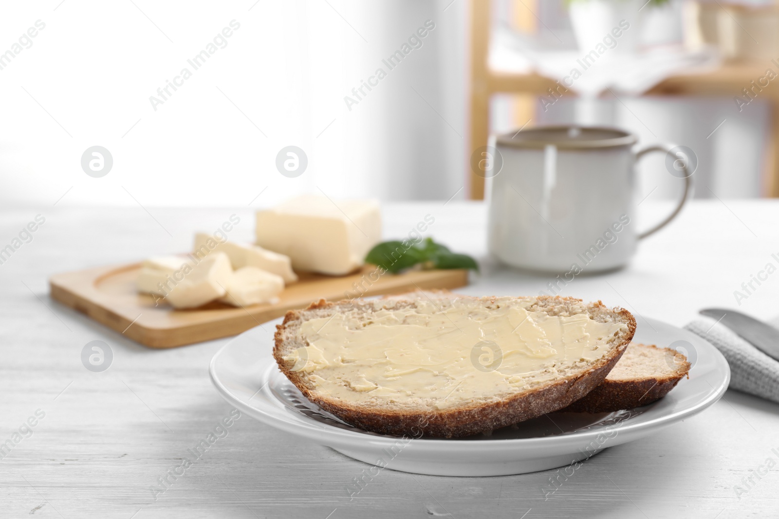 Photo of Fresh bread with tasty butter on plate