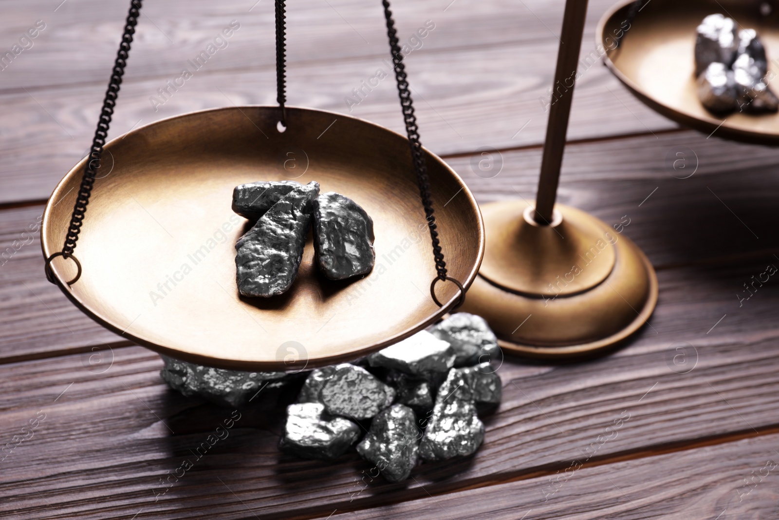 Photo of Vintage scales with silver nuggets on wooden table