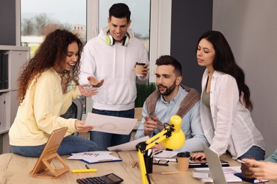 Photo of Team of employees working together in office. Startup project