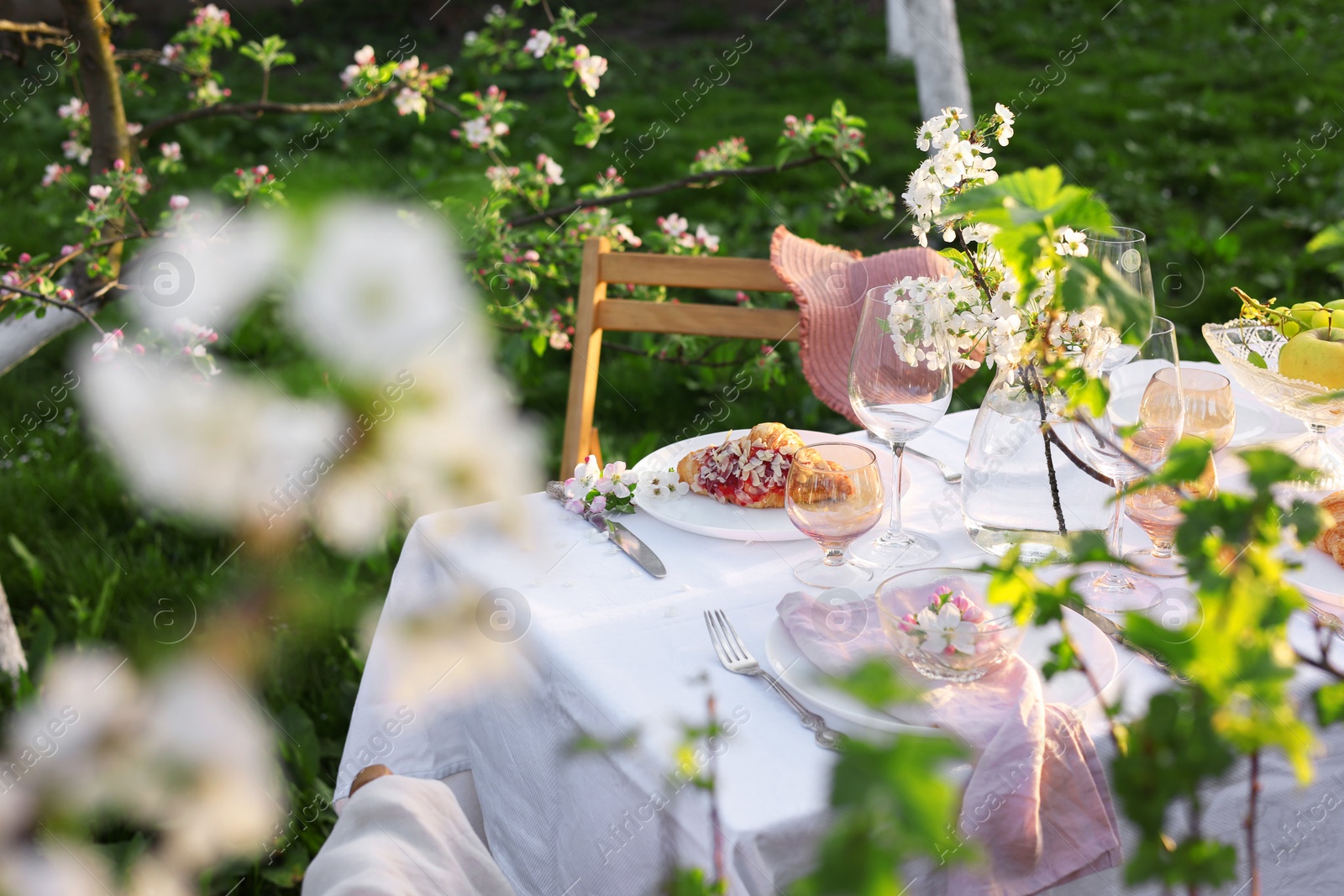 Photo of Stylish table setting with beautiful spring flowers in garden