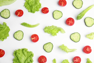 Photo of Fresh vegetables for salad on white background, top view