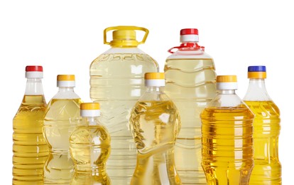 Photo of Bottles of cooking oil on white background