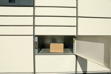 Photo of Open box with package in parcel locker