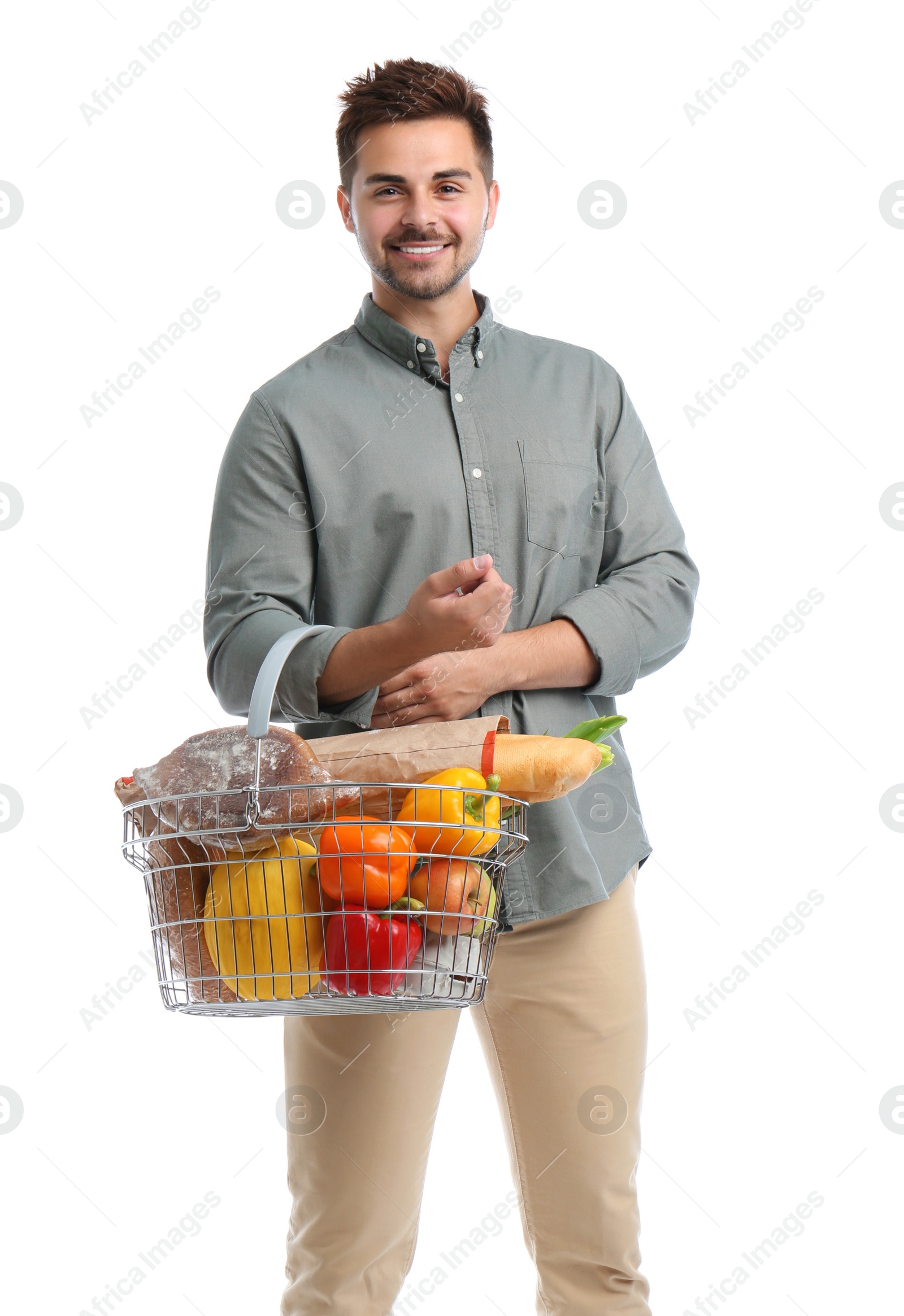 Photo of Young man with shopping basket full of products isolated on white