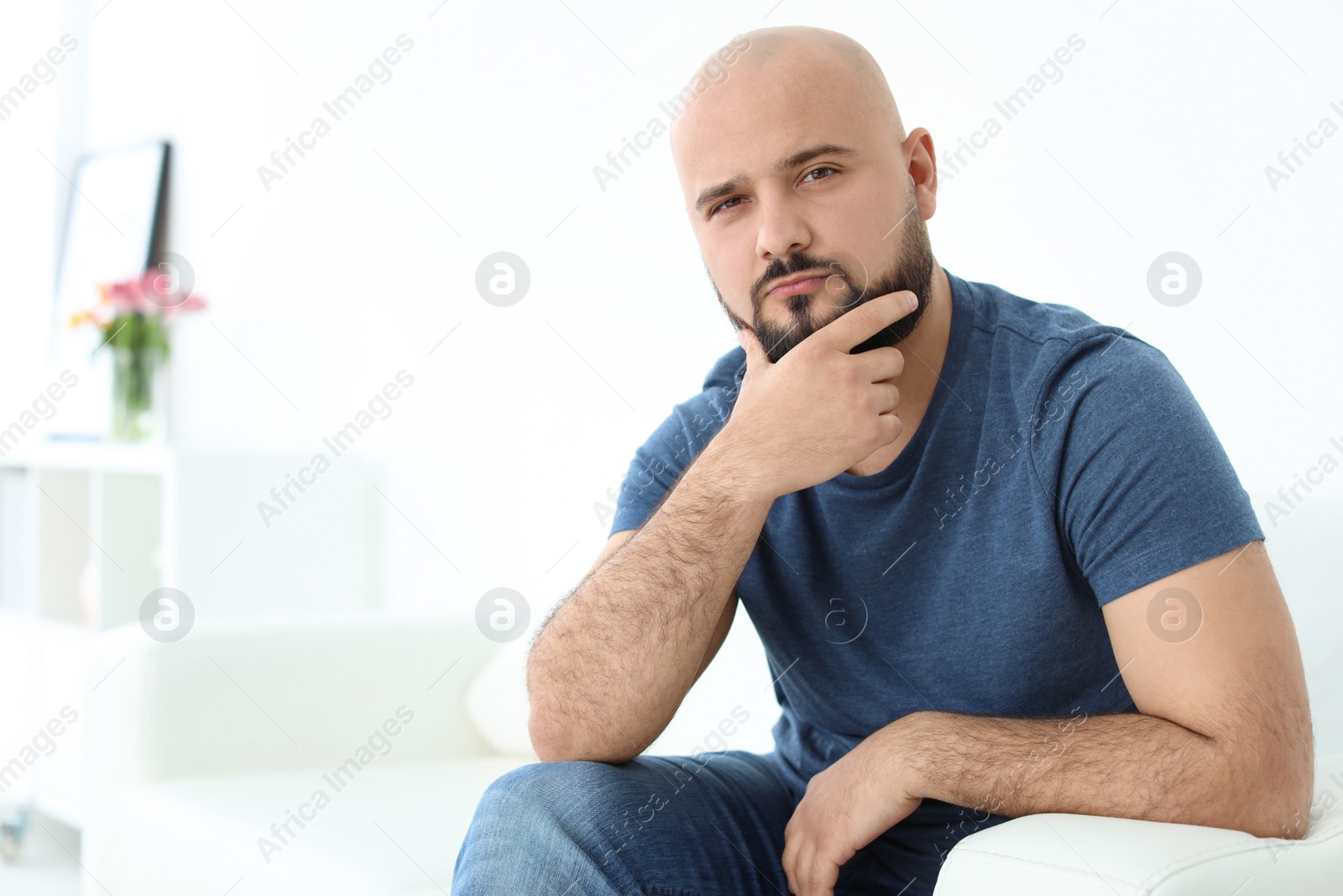 Photo of Portrait of confident young man on sofa