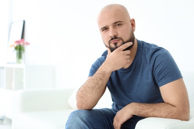 Portrait of confident young man on sofa