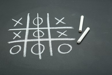 Photo of Tic tac toe game drawn on chalkboard