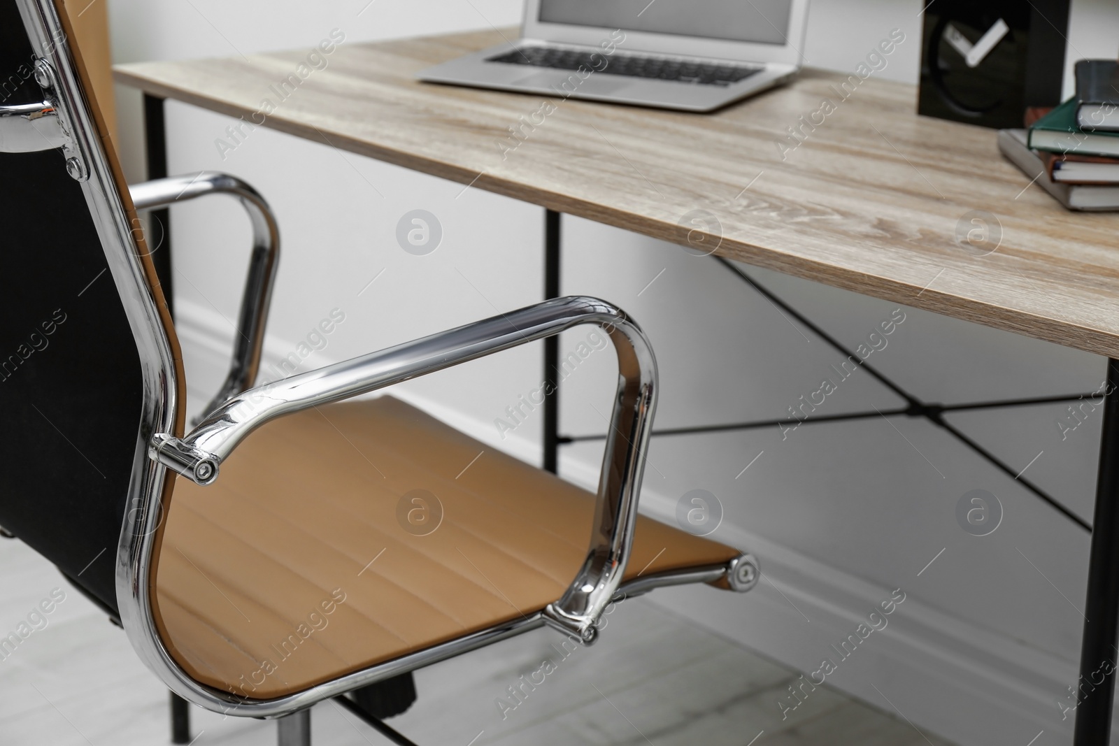 Photo of Modern office chair in stylish workplace interior