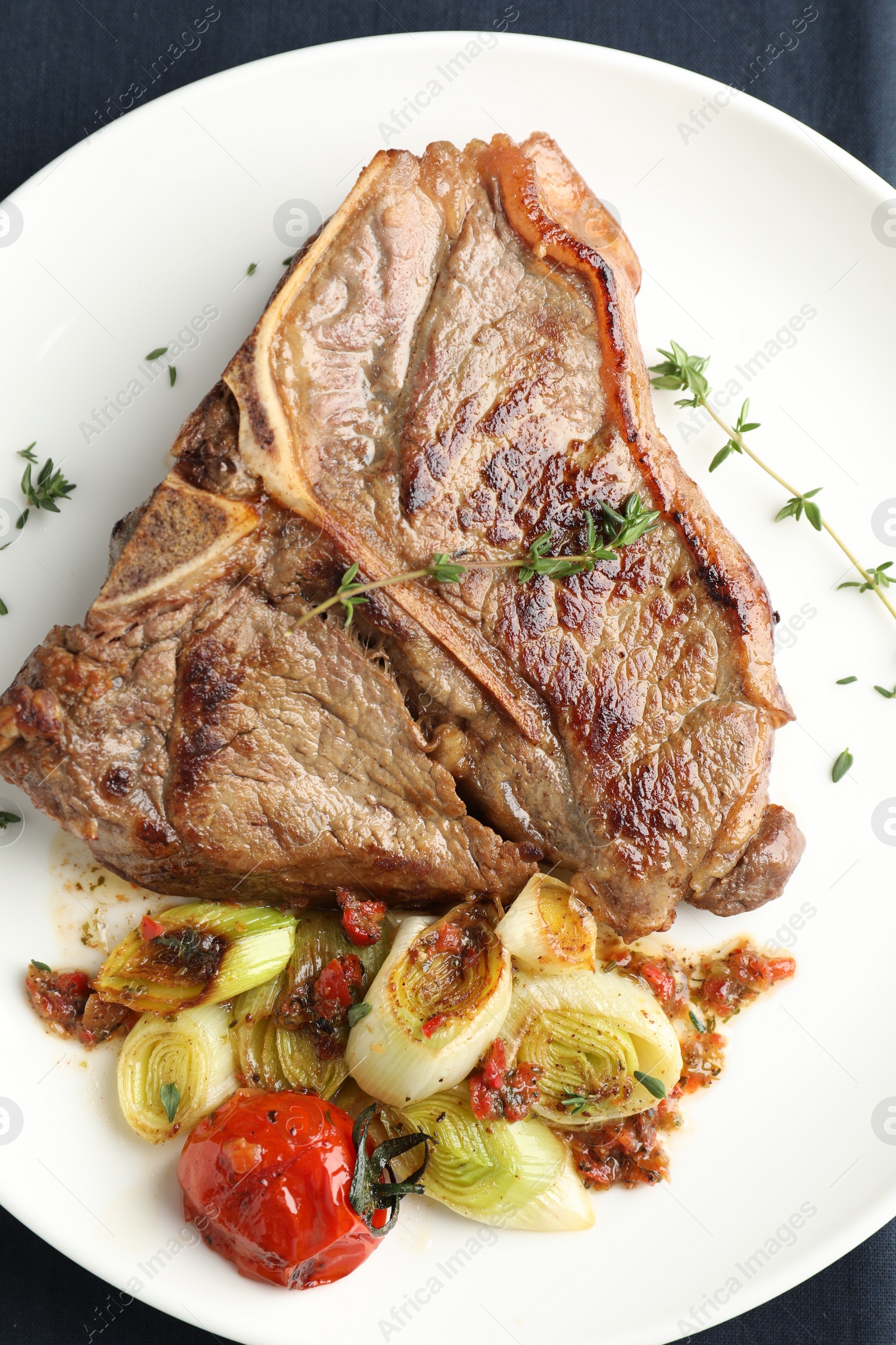 Photo of Delicious fried beef meat and vegetables on table, top view