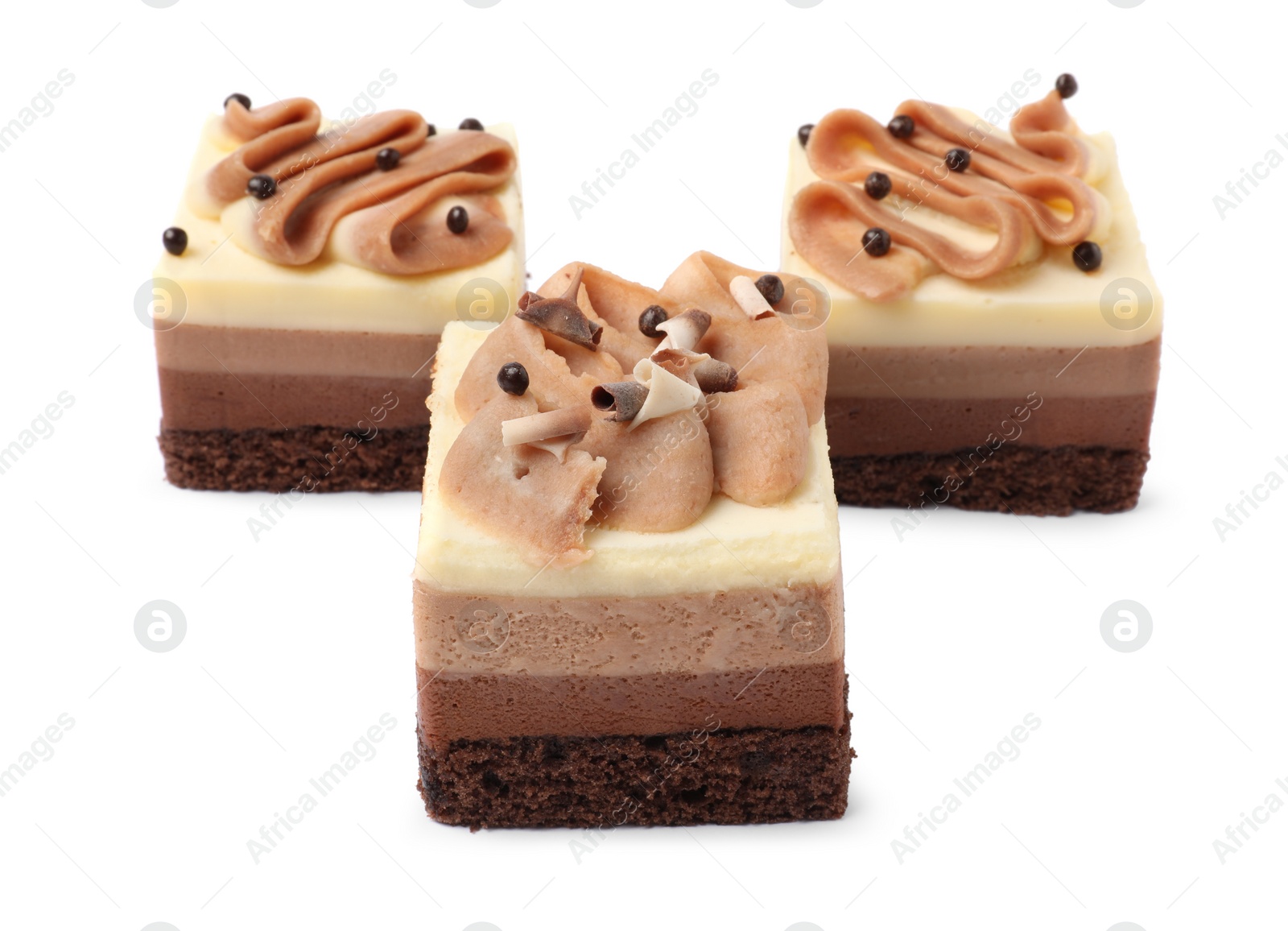 Photo of Pieces of triple chocolate mousse cake on white background