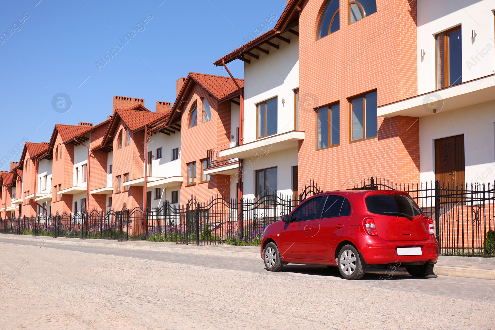 Photo of Color family car near modern buildings in city. Space for text