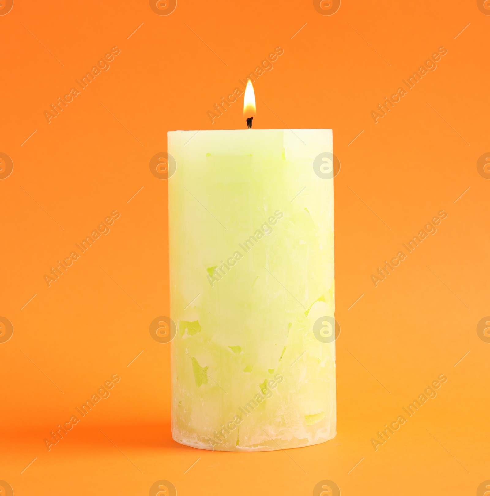 Photo of Alight scented wax candle on color background