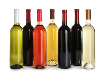 Bottles with different wine on white background