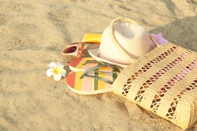 Composition with bright beach accessories on sand