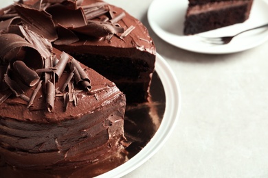 Photo of Tasty homemade chocolate cake on table, closeup. Space for text