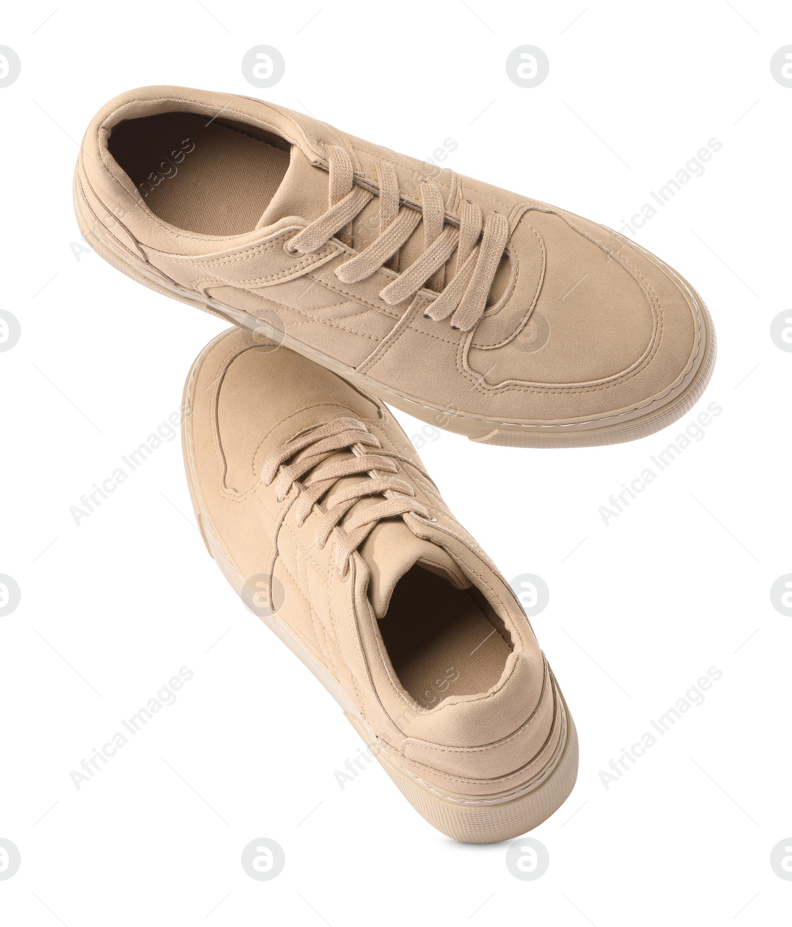 Photo of Pair of stylish beige sneakers isolated on white