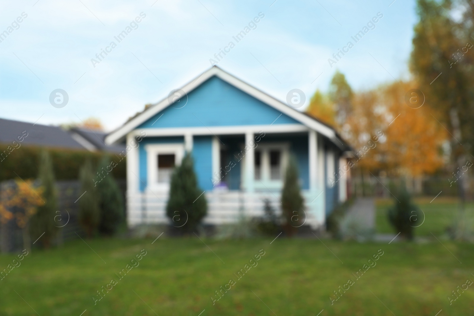 Photo of Blurred view of beautiful light blue house outdoors. Real estate