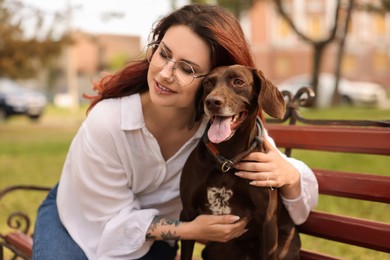 Photo of Woman with her cute German Shorthaired Pointer dog outdoors