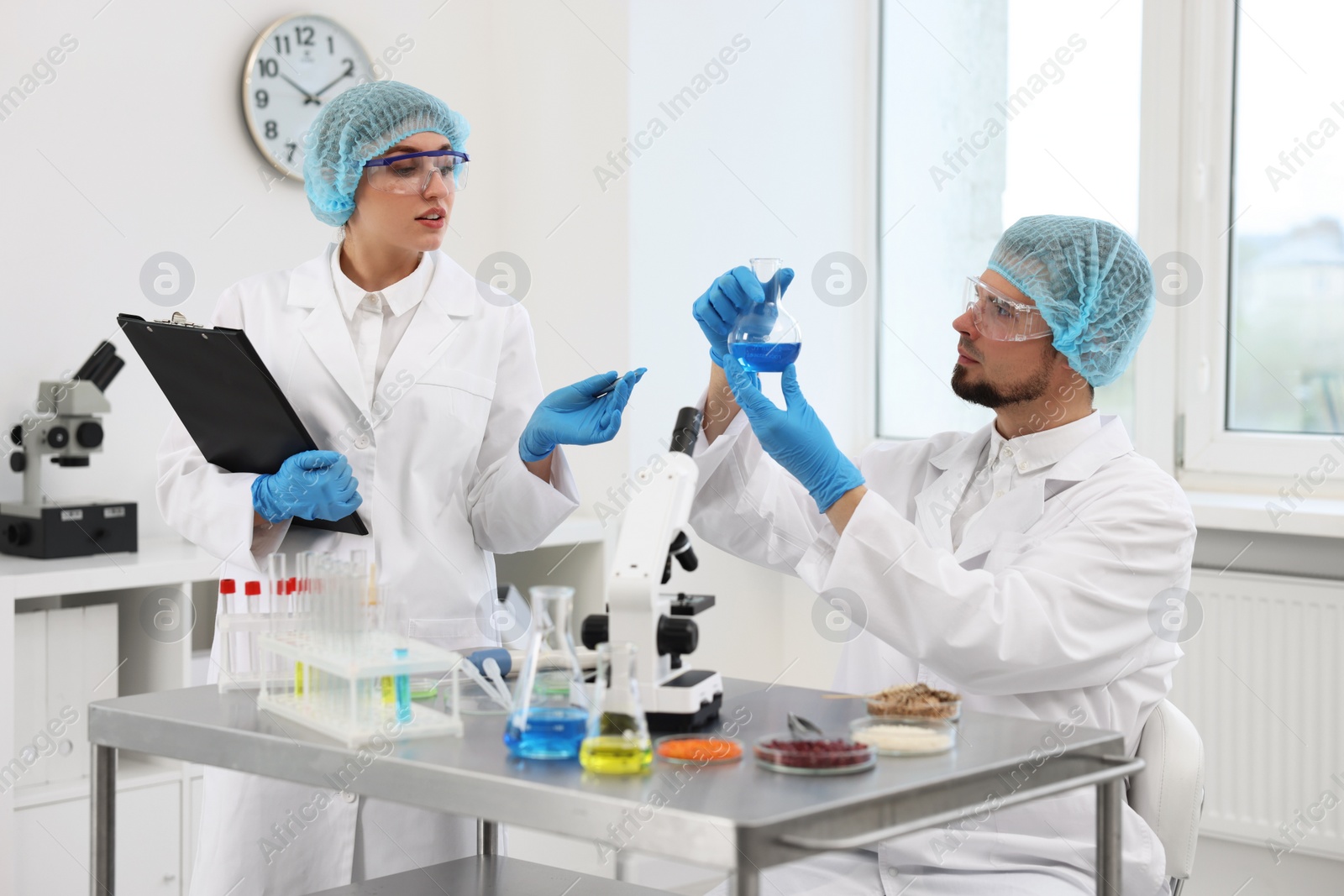 Photo of Quality control. Food inspectors checking safety of products in laboratory